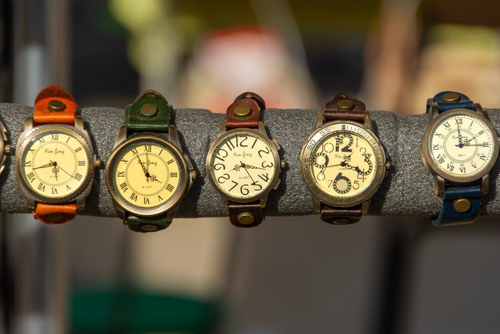 Assorted vintage german watches with leather straps on a display rack.