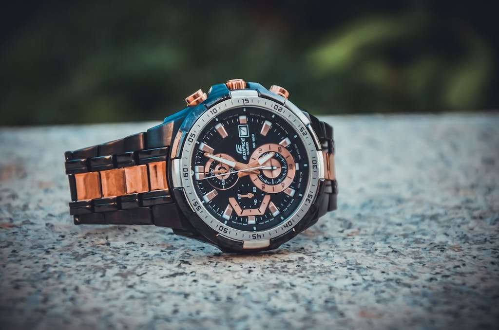 Close-up of an elegant wristwatch with a metal band, highlighting its intricate design and timekeeping features.