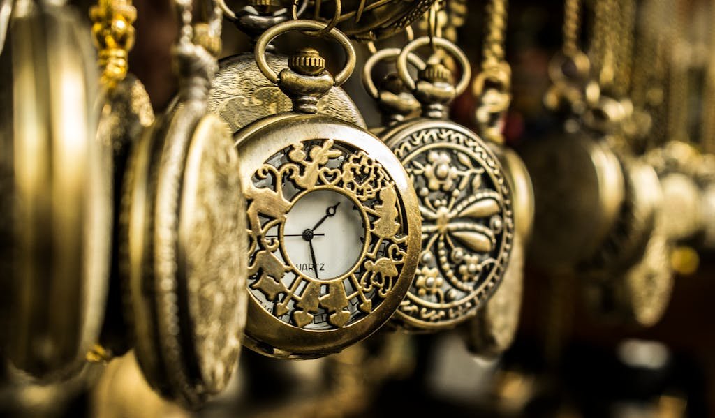 Close-up of ornate vintage pocket watches showcasing intricate designs and luxury aesthetics.